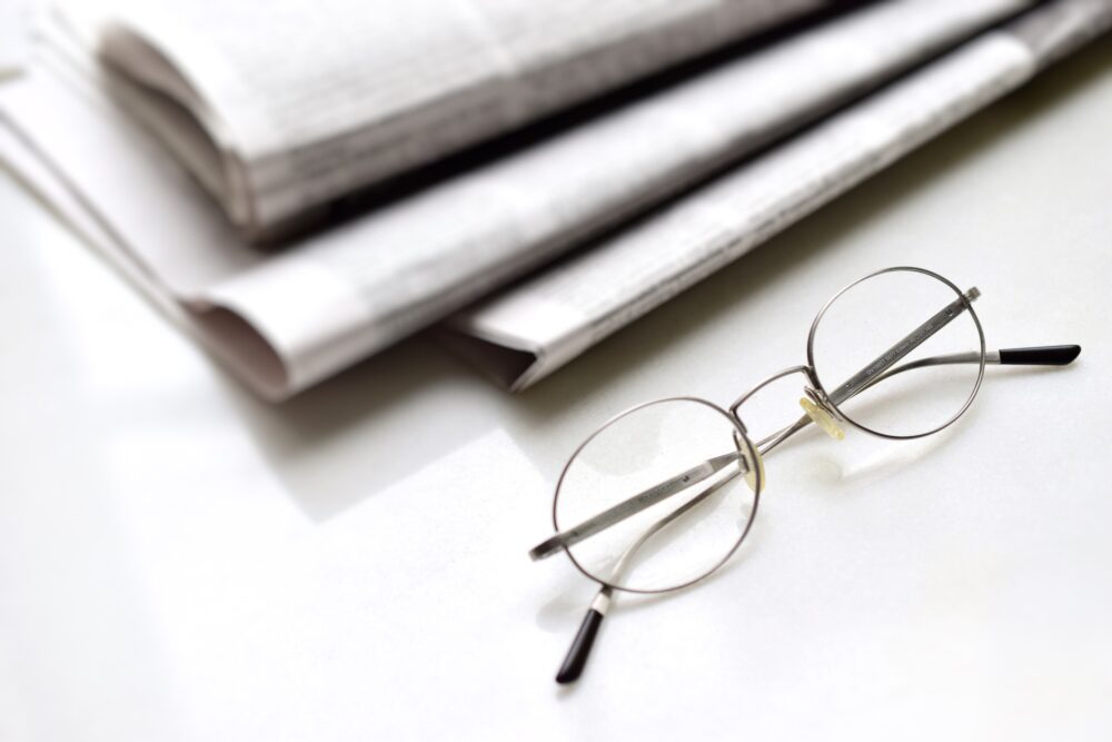 Reading glasses and newspapers on the table